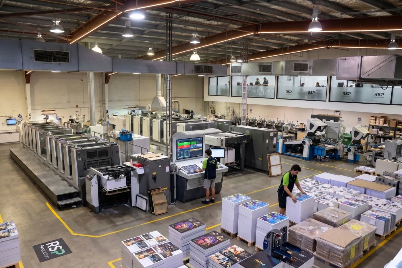 Inside Ready Steady Print's Melbourne print floor — offset presses running, staff checking a job, finished stock ready to ship