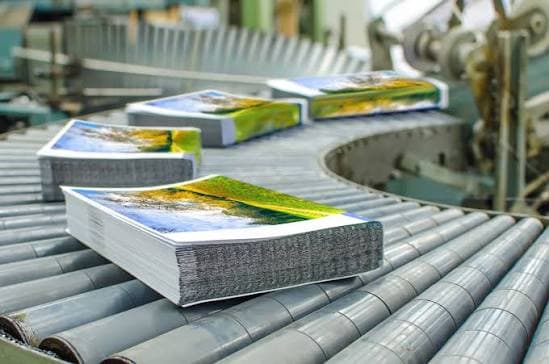 Finished, bound books moving along the production line, ready to ship