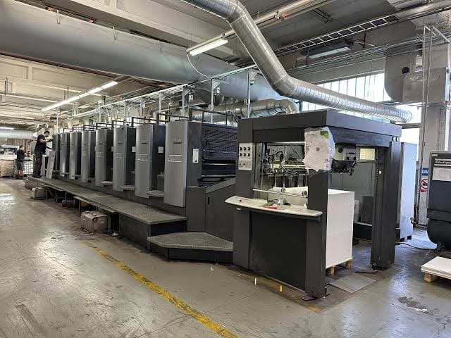 An offset press line on the RSP print floor, with staff at work in the background